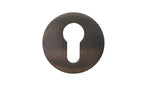 Bronze keyhole cover on a white background