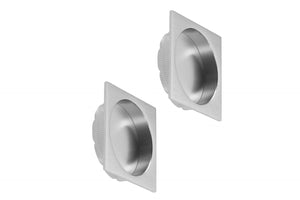 Two metallic square flaps on a white background