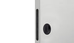 Close-up of a white cabinet with a black handle on a white background