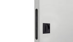 Close-up of a white door with a black handle on a light gray background
