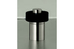 Metallic cylindrical object with black top on a reflective surface