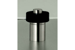 Metallic cylindrical object with black top on a reflective surface