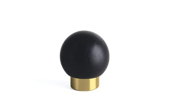 Black spherical knob with gold base on a white background