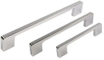 Set of four chrome cabinet handles on a white background
