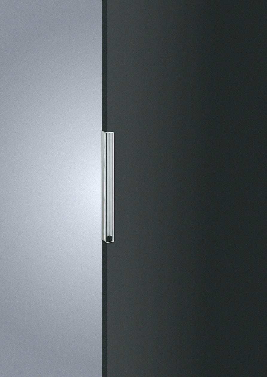 Close-up of a refrigerator door handle on a black and silver refrigerator.