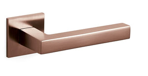 Rose gold door handle on a white background