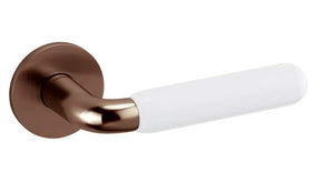 Bronze door handle with white handle on a white background