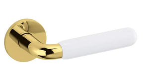 Gold door handle with white handlebar on a white background