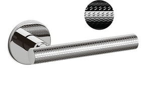 Chrome door handle with textured design on a white background