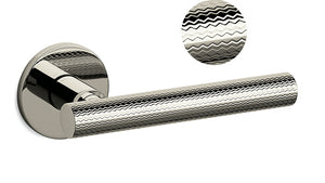 Metallic door handle with textured design on a white background