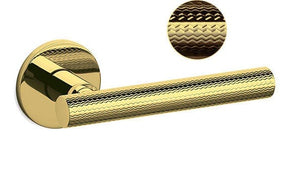 Gold door handle with textured design on a white background