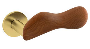 Door handle with wooden lever and brass cylindrical part on a white background