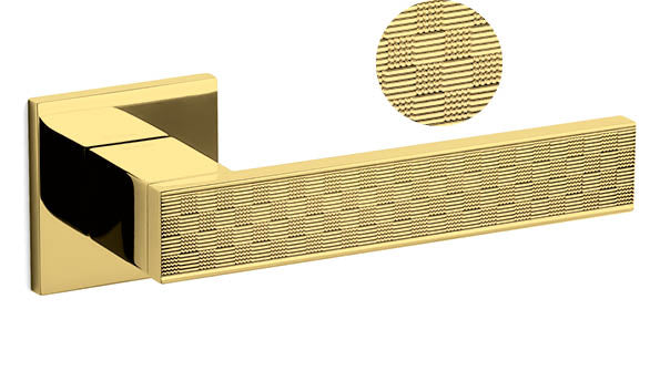 Gold door handle with textured finish on a white background