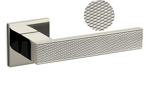 Metallic door handle with textured design on a white background