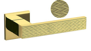 Gold door handle with textured design on a white background