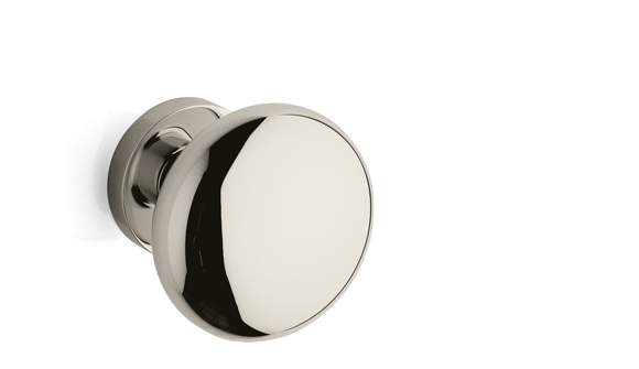 Polished chrome door knob on a white background