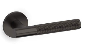 Black textured door handle on a white background
