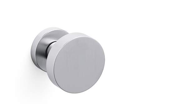 Round metallic object with white center on a white background