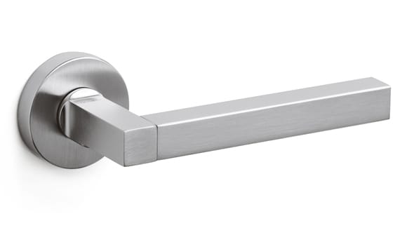 Stainless steel door handle on a white background