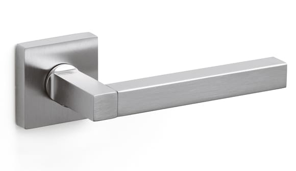 Stainless steel door handle on a white background